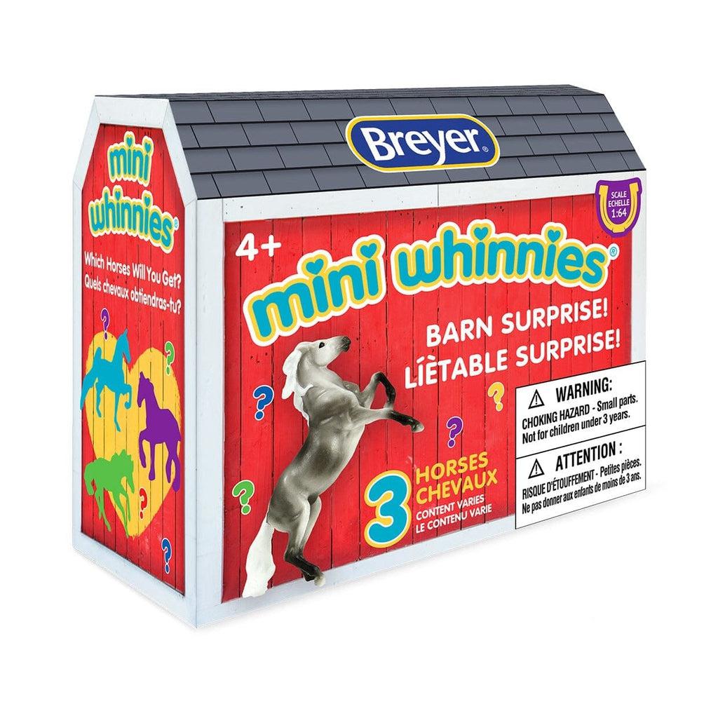 Image of the Mini Whinnies Barn Surprise blind box. It is shaped and printed to look like a barn and it has a picture of some of the possible included horse figurines.