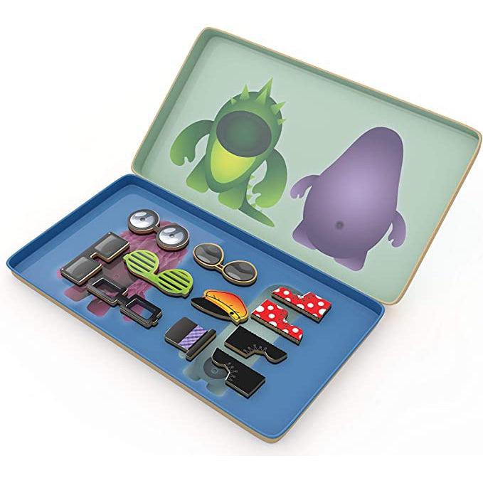 Image of the inside of the game tin. On both sides there are two different monster bodies each that are sized to match the accessory items you can place on top of them.