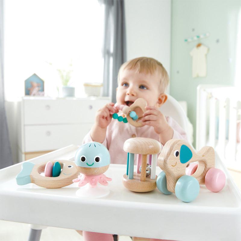 Scene of a baby playing with the sensory toys.