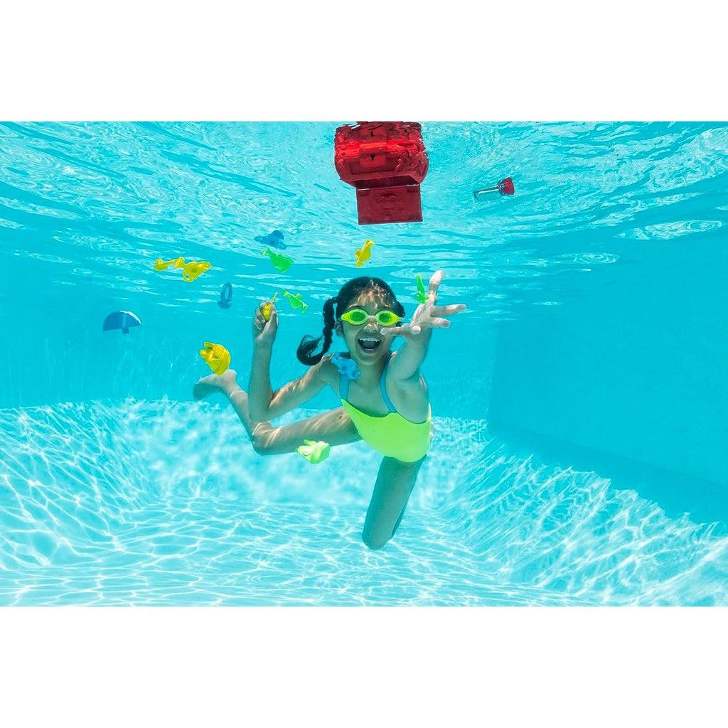 A child is underwater reaching out towards the sinking treasures that are dropping from the chest which is floating upside down at the surface