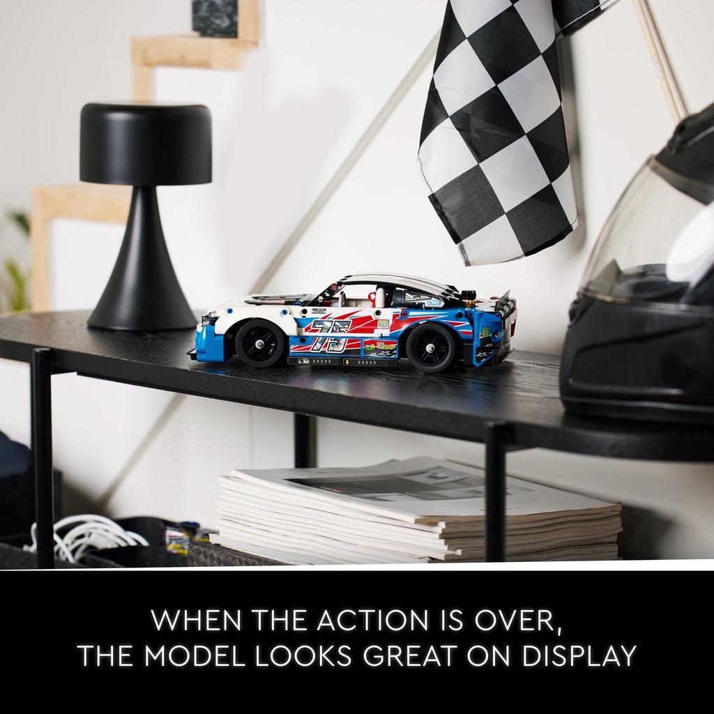 car displayed on a modern side table next to a nascar helmet and a checkered flag | text reads: When the action is over, the model looks great on display
