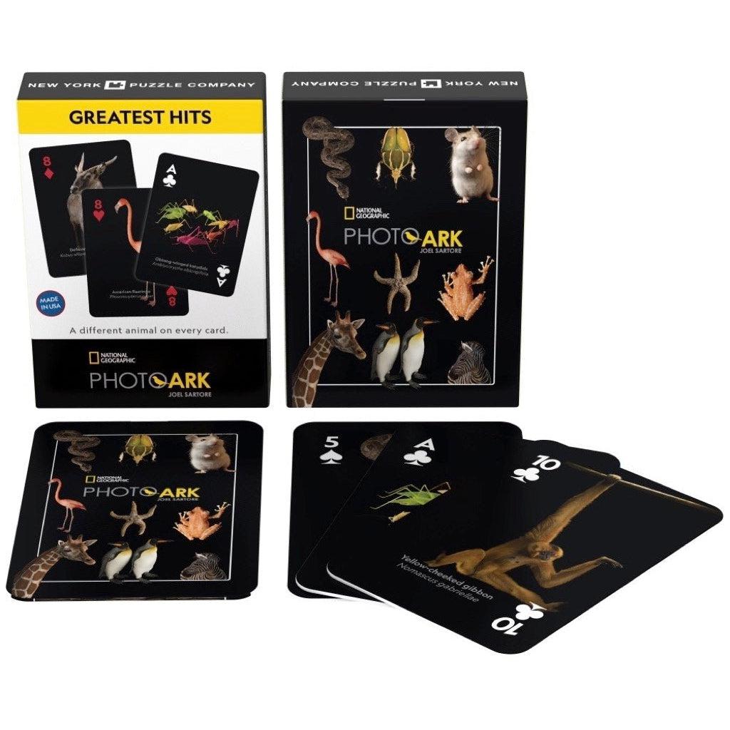 Image of the box, the back of the deck, and the face of three example cards. Each card has a black background to emphasize the pictures of the animals.