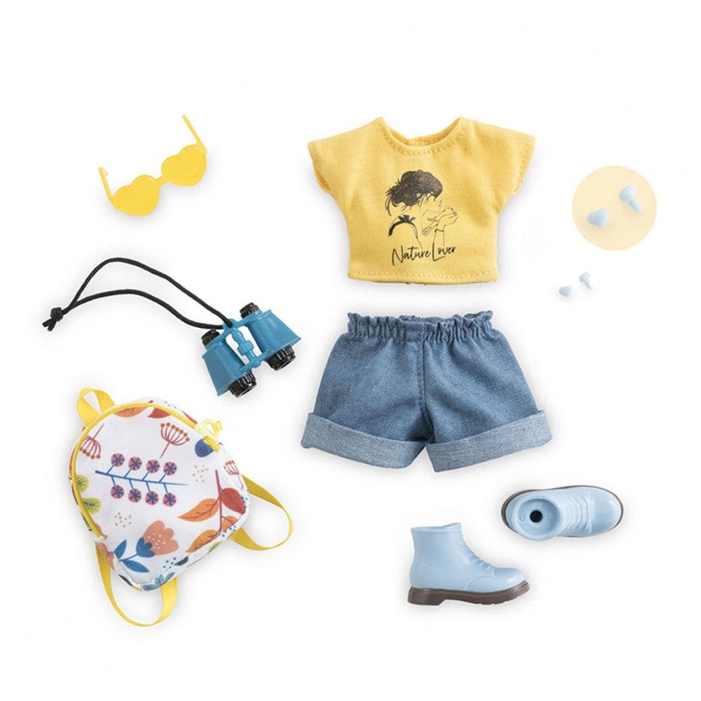 Image of the included pieces. The set includes a yellow "Nature Lover" shirt, denim shorts, yellow heart-shaped sunglasses, binoculars, a nature themed backpack, blue shoes, and white heart-shaped earrings.