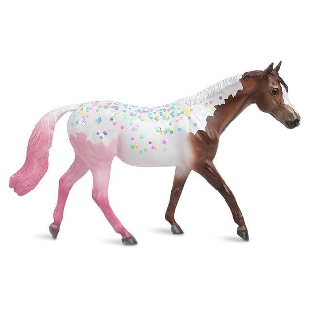 Image of the Neapolitan Horse figurine. it is a chocolate brown horse, a white rainbow sprinkled back, and strawberry pink back legs and tail.