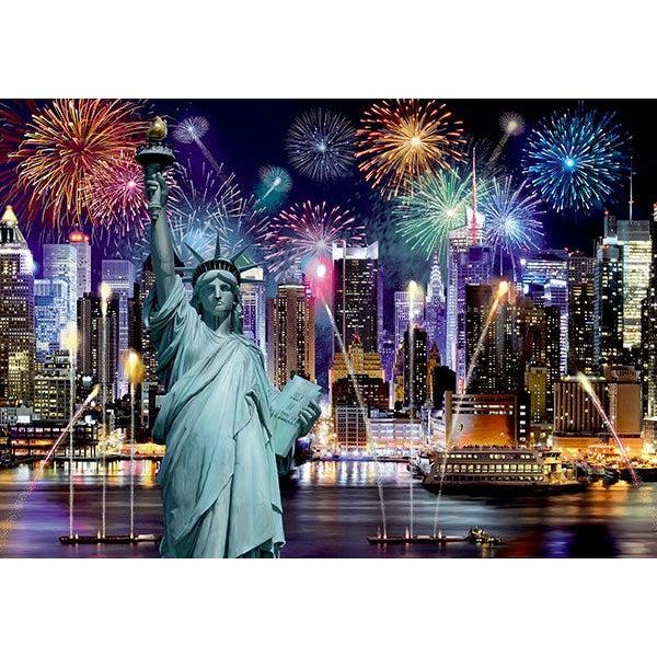 The puzzle is of New York at night. Fireworks fill the sky, the Statue of Liberty is in the front of the puzzle with the New York skyline in the background.