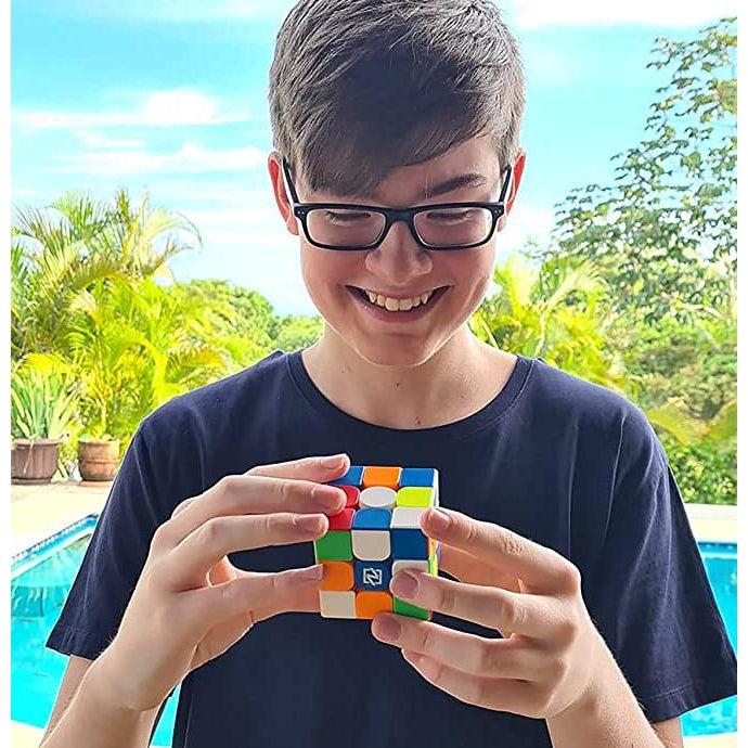 Scene of a boy smiling and playing with his new cube.