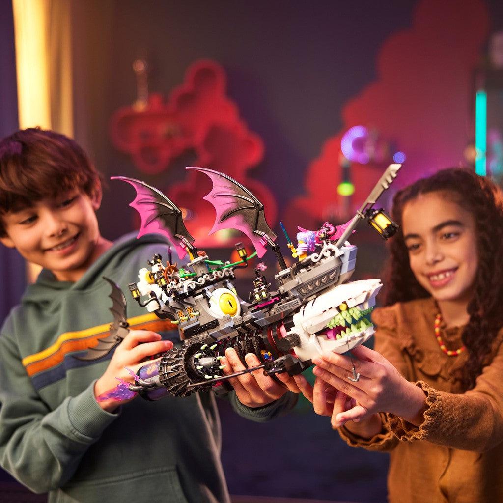 image shows two kids playing with the nightmare shark ship