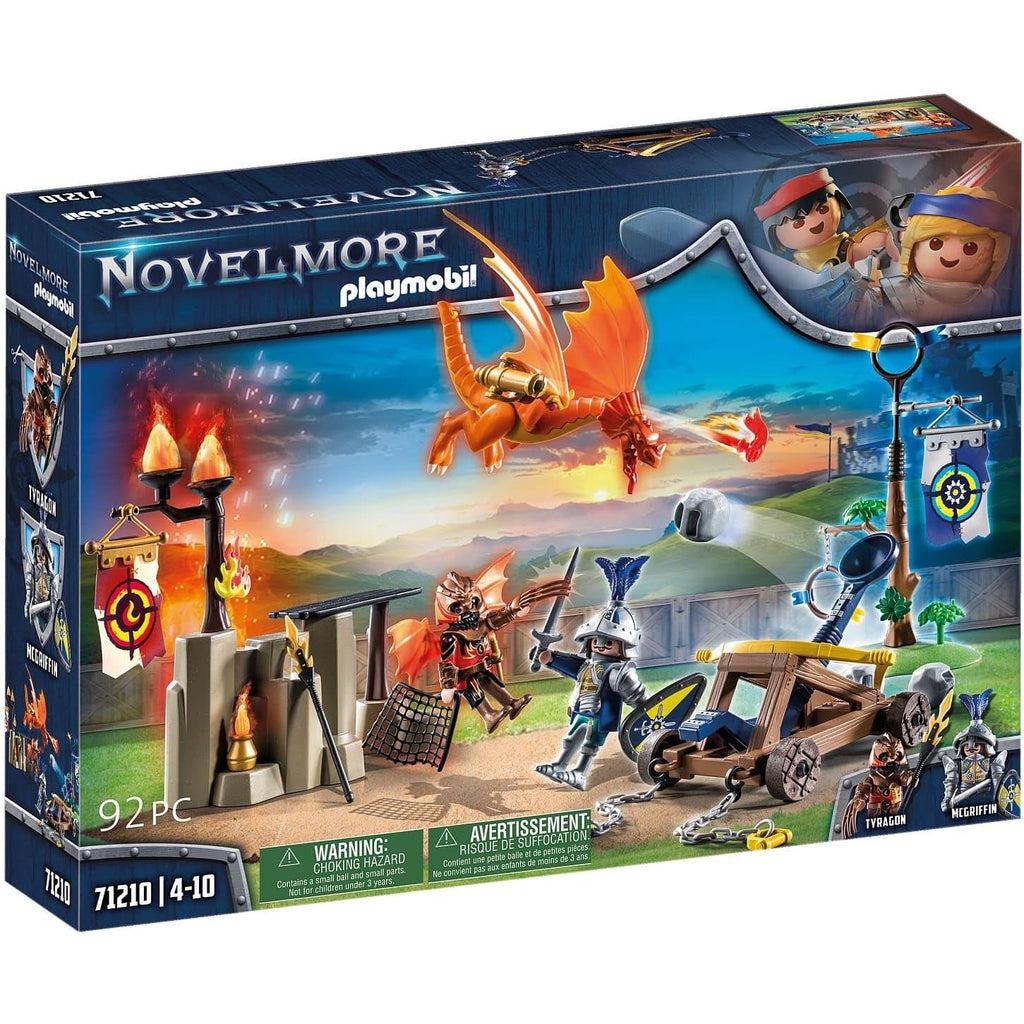 Image of the playmobil box for the novelmore set, including 92 pieces. the art shows a knight with a catapult attacking a dragon