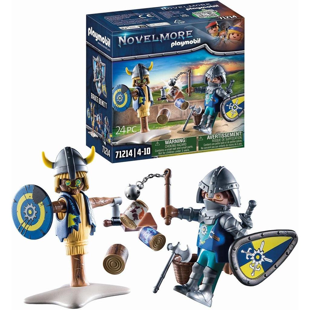 this picture shows the box in the background while the knight and dummy are more clearly seen, showing that the toy looks like, the knight has a helmet on and an axe next to him. he is using a flail, but has a sword in the other hand, covered by a floating shield. 