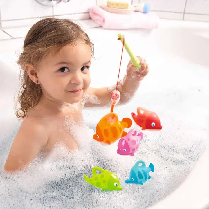 Scene of a little girl playing with the toy in the bath.