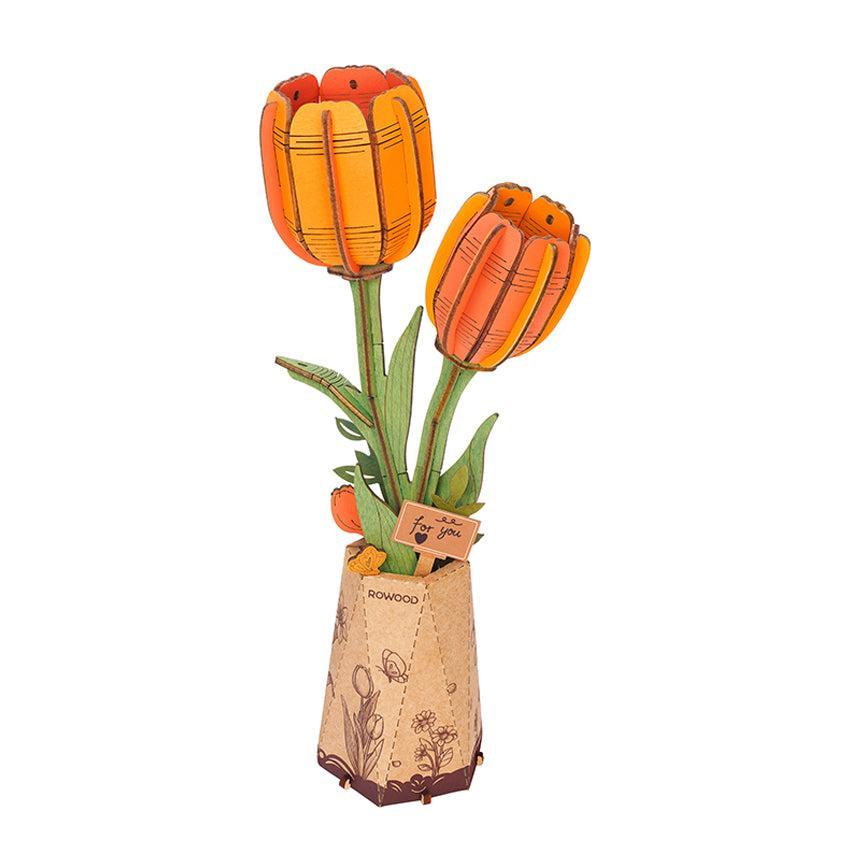 Two orange wood tulips in a decorative vase with a small card that says "for you.