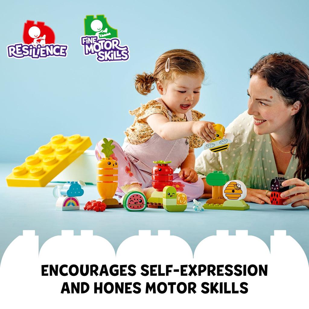 Scene of a mother playing with her daughter as she plays with the Duplo playset. Caption: encourages self-expression and hones motor skills.