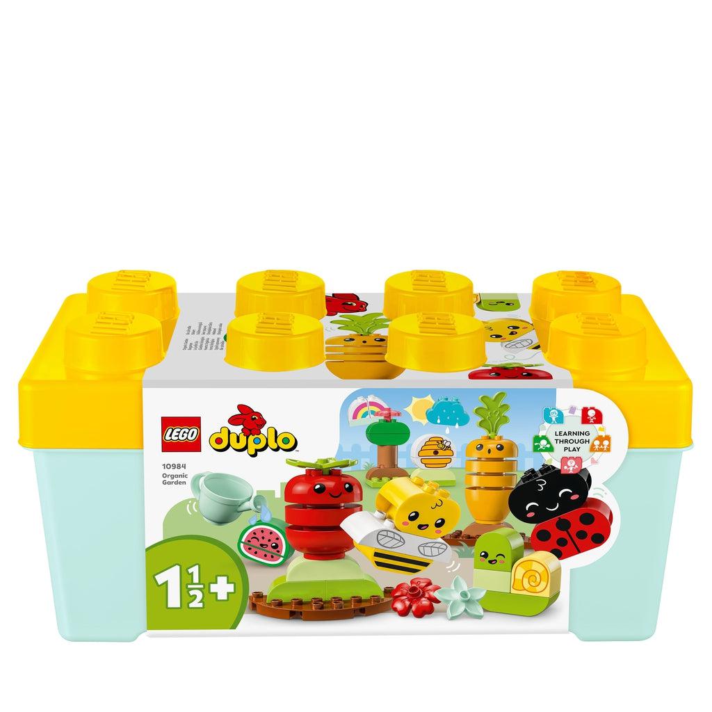 Image of the box for the Organic Garden Duplo LEGO set.  It comes in a LEGO-shaped plastic bin with cardboard surrounding it with a picture of some of the bricks included in the set.