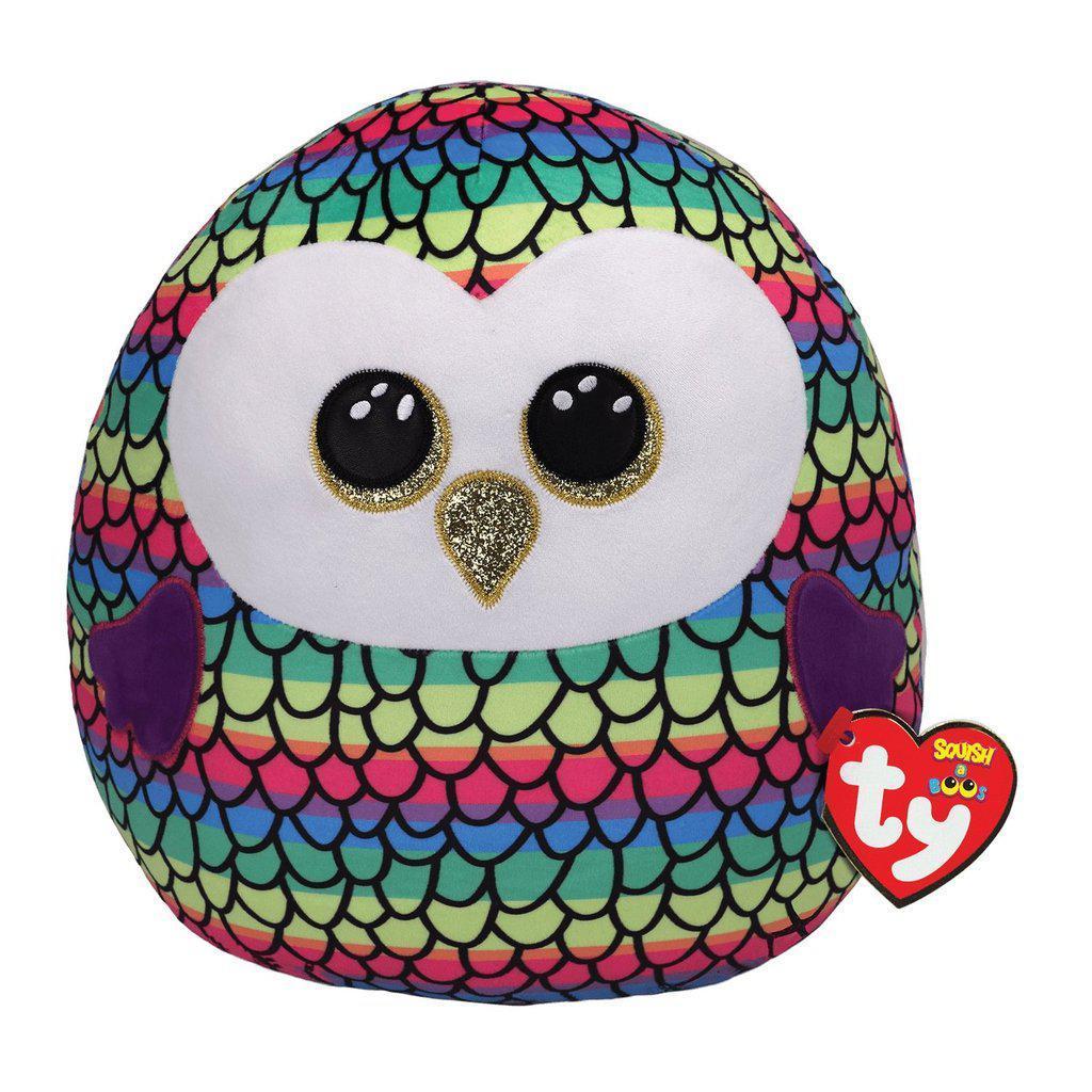 Image of the Owen Rainbow Owl Squish-A-Boo plush. It is a rainbow striped plush with a black feather pattern on top. It has glittery golden eyes and beak.
