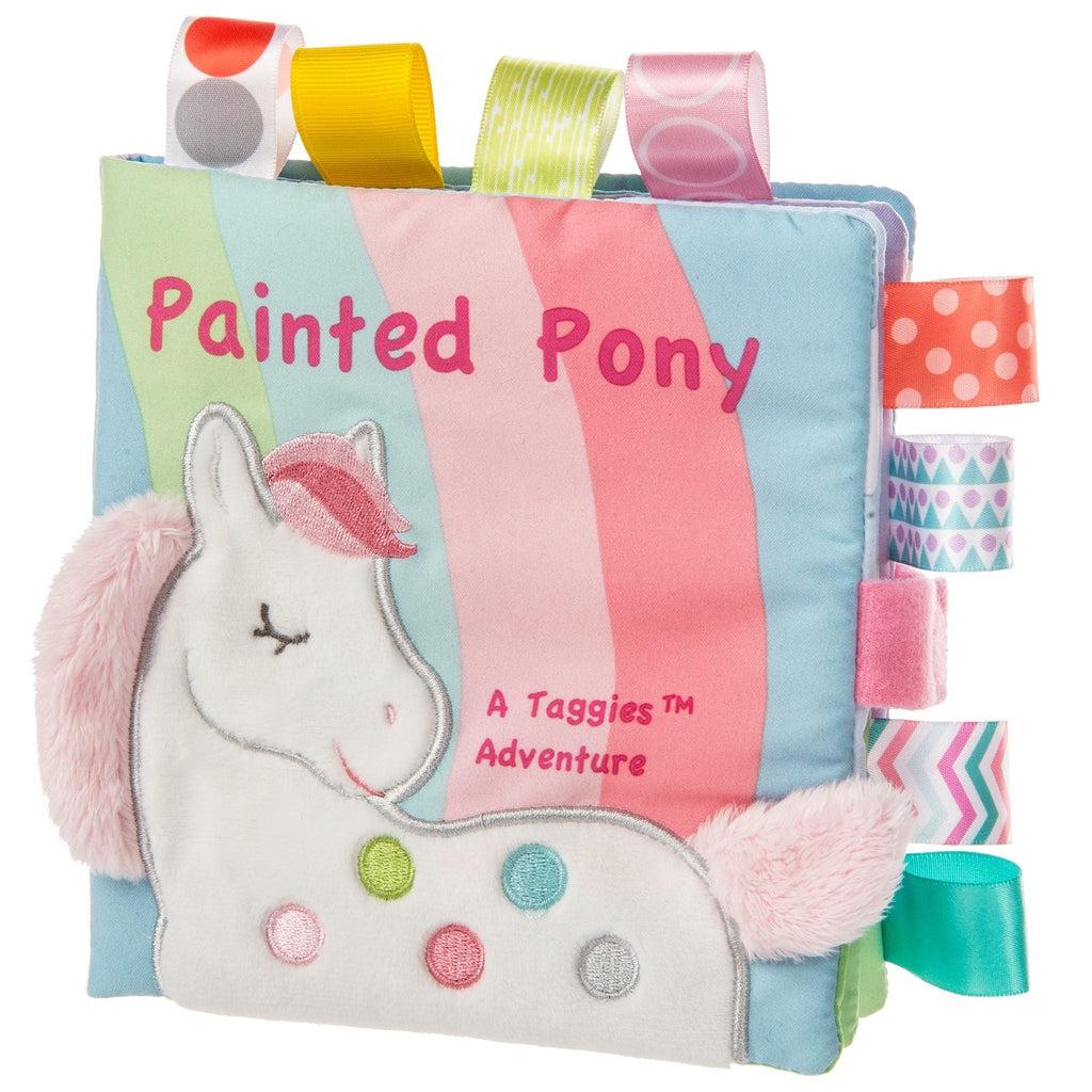 Image of the Painted Pony Soft Book with Taggies. On the front is a felt pony, and on the sides are many different ribbon tags that can be played with and chewed on.