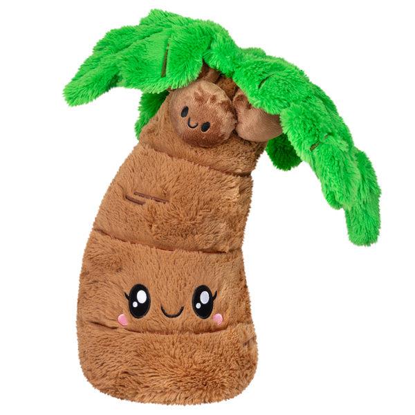 Image of the Palm Tree squishable. It is a brown curved palm tree with large green leaves and smiling coconuts.