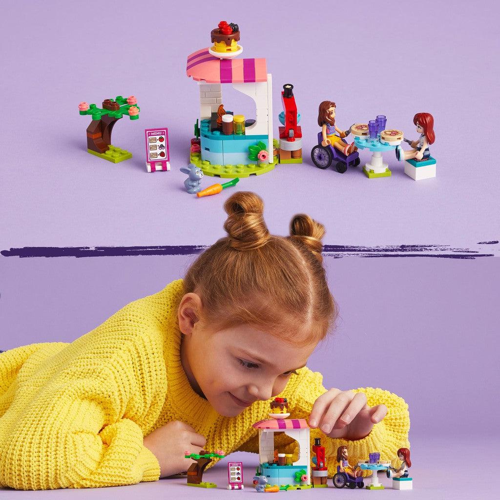 image shows a child building and playing with the LEGO friends pancake shop