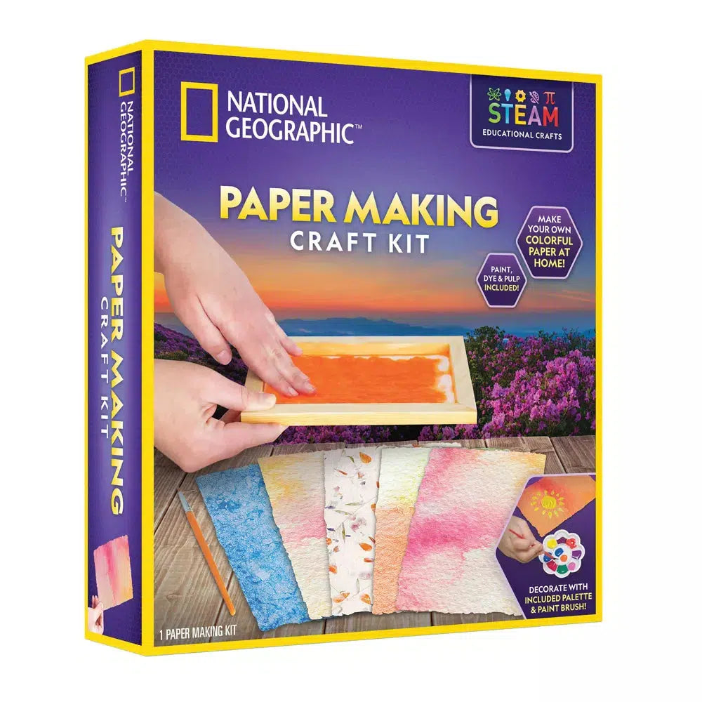 image depicts the box for the national geographic maper making kit, hands are placing orange paper paste into a mold and pressing down to start making paper. a sign says "make your own colorful paper at home! paint dye and pulp included" a sign at the bottom reads "decorate with included palette and paint brush"