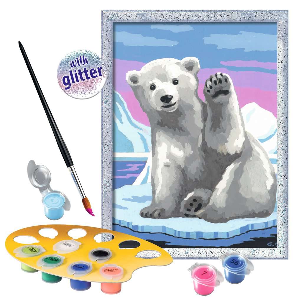this picture shows the paint in an easel with a paint brush coated in blue to paint the ice the polar bear is sitting on. the frame is covered in glitter for extra sparkle. 