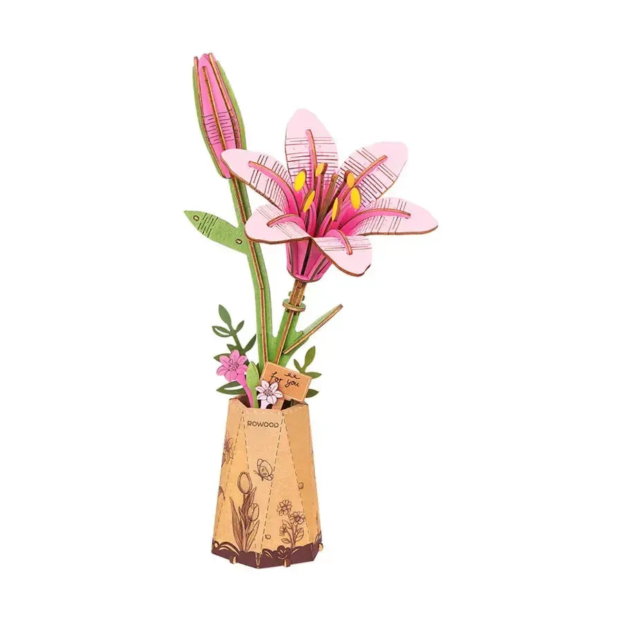 A wood sculpture of a pink lily in a brown vase. The flower's petals and leaves are intricately detailed with geometric designs.