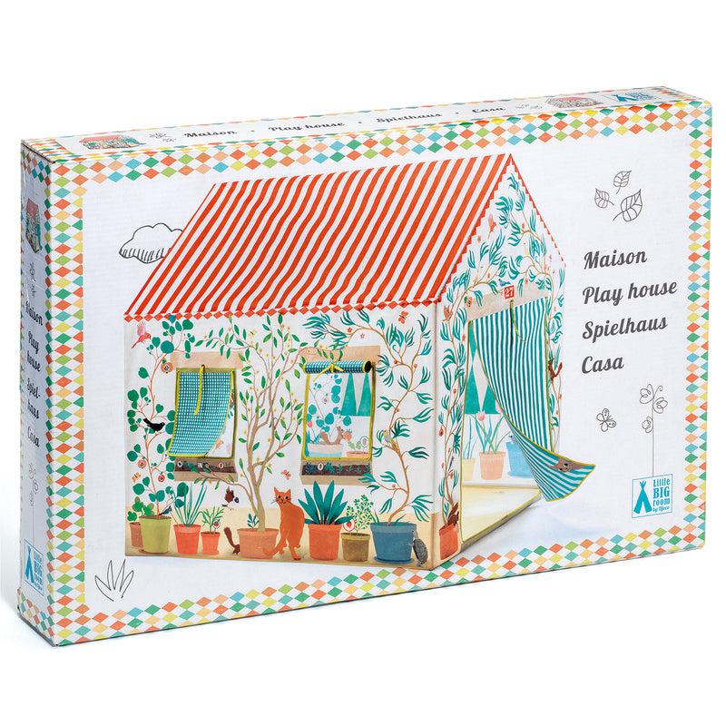 the box image shows a colorful play house  with vines on the walls, a red and white striped roof and a tent flap for the door. the border of the house on the bottom shows potted plants and a cat.