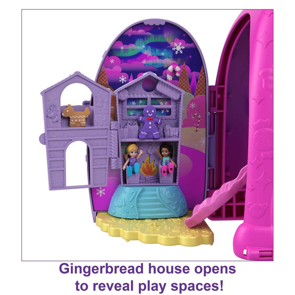 Shows the gingerbread house in more detail. The house is purple with  beds and chairs inside.