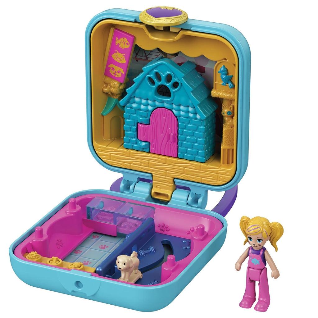 Image of the pet shop themed Tiny Compact. It includes a Polly Pocket with cat face paint and a dog. The inside has a store front/dog house and a store area that has treats and enclosures.
