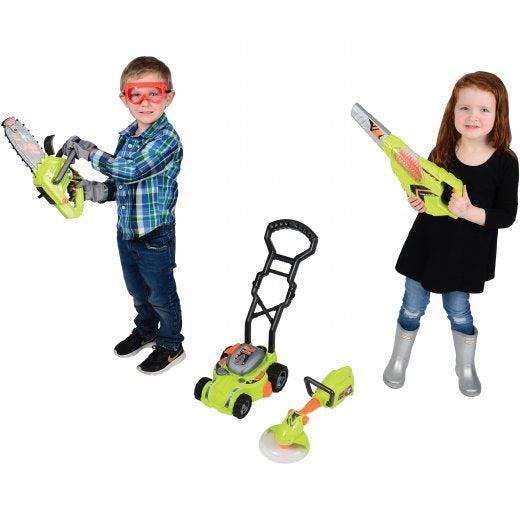 this image shows a boy with goggles and cloves holding a chain saw and a girl holding a leaf blower. the lawn mower and weed wacker are at their feet