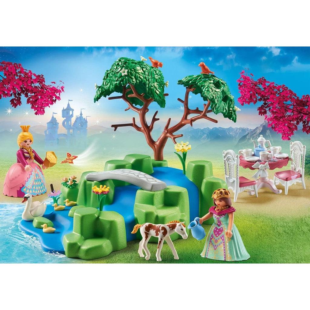 Picture is the display on the box, without the details of choking hazzard. there are three birds in a wide tree as a princess walkes over a bridge, another princess is giving the baby foal a drink from a pitcher of water