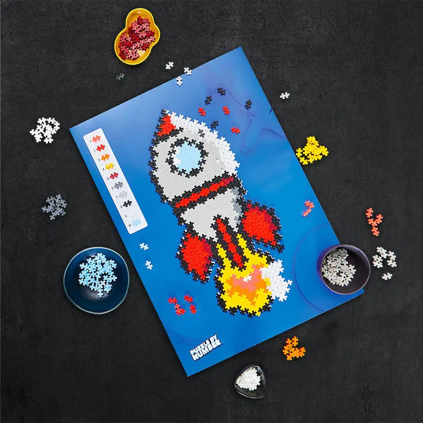 Image of a half-built rocket ship puzzle. Shows that it is made from 10 different colors of puzzle pieces.