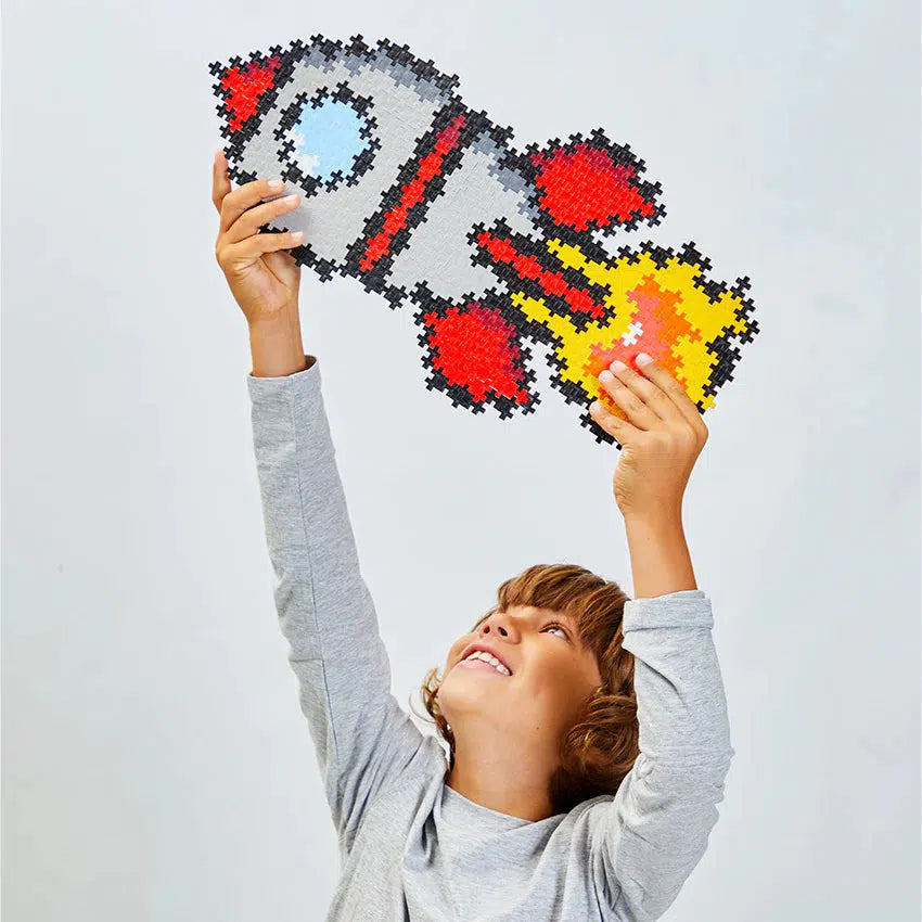 Scene of a little kid triumphantly holding up the finished puzzle.