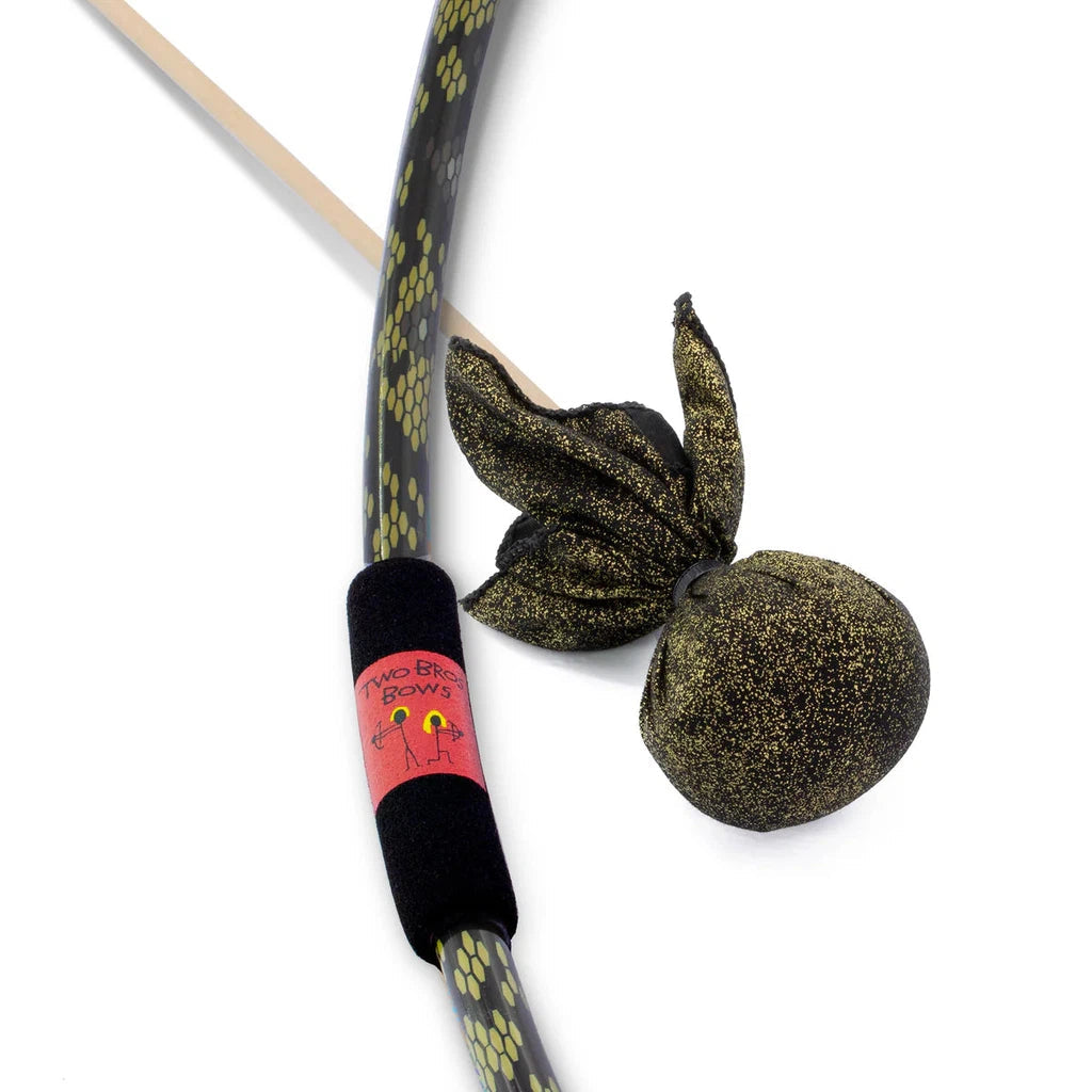 a bow with a green and black snake skin pattern and a foam grip next to an arrow with a large soft rounded yellow and black metallic colored tip