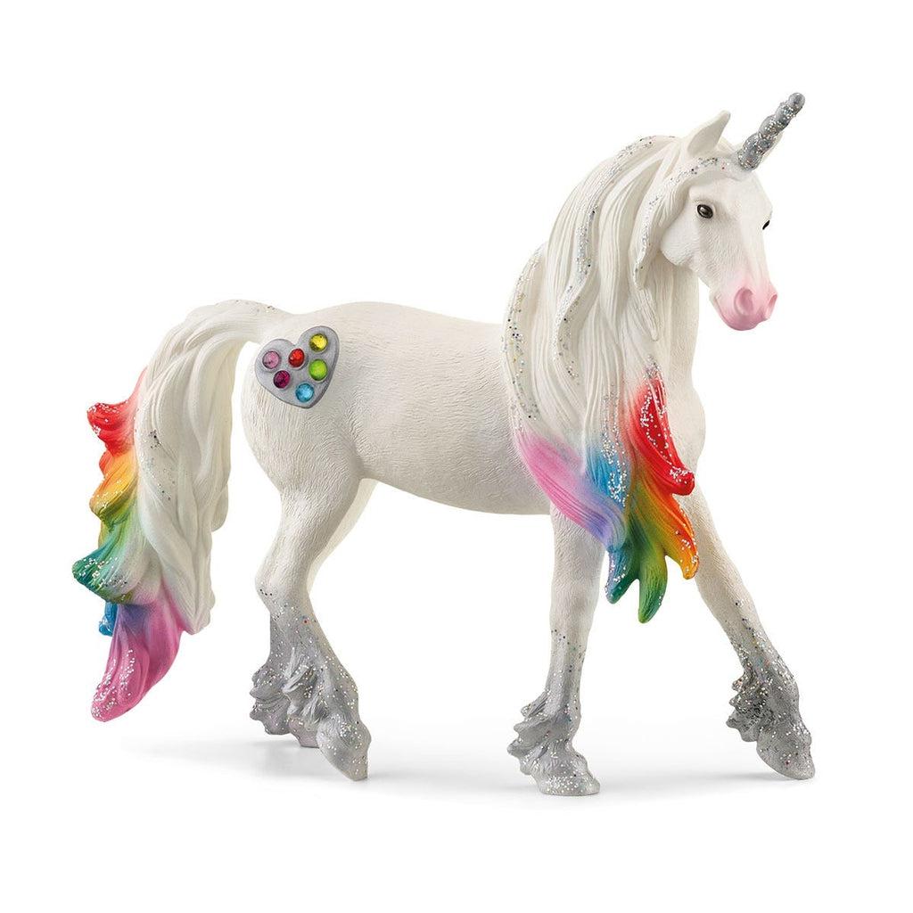 Image of the Rainbow Love Unicorn Stallion figurine. The unicorn is white silver glittery hooves. The mane and tail are white with the tips of the hair colored to look like a rainbow. He has a silver heart cutie mark with rainbow jewels embedded inside.