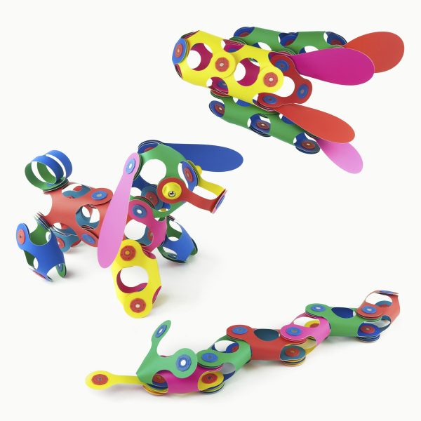 Colorful interlocking Clixo toy pieces forming abstract shapes on a white background.