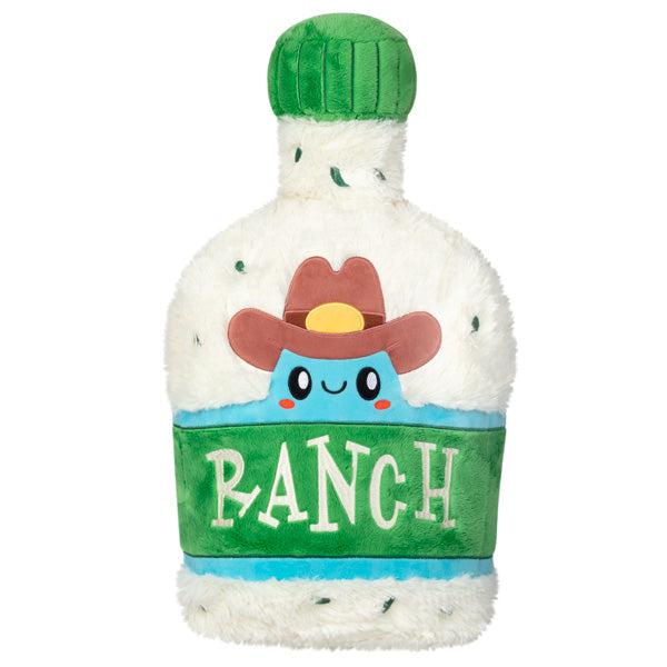 Image of the Ranch squishable. It is a bottle of ranch plush with a blob in a cowboy hat on the front.