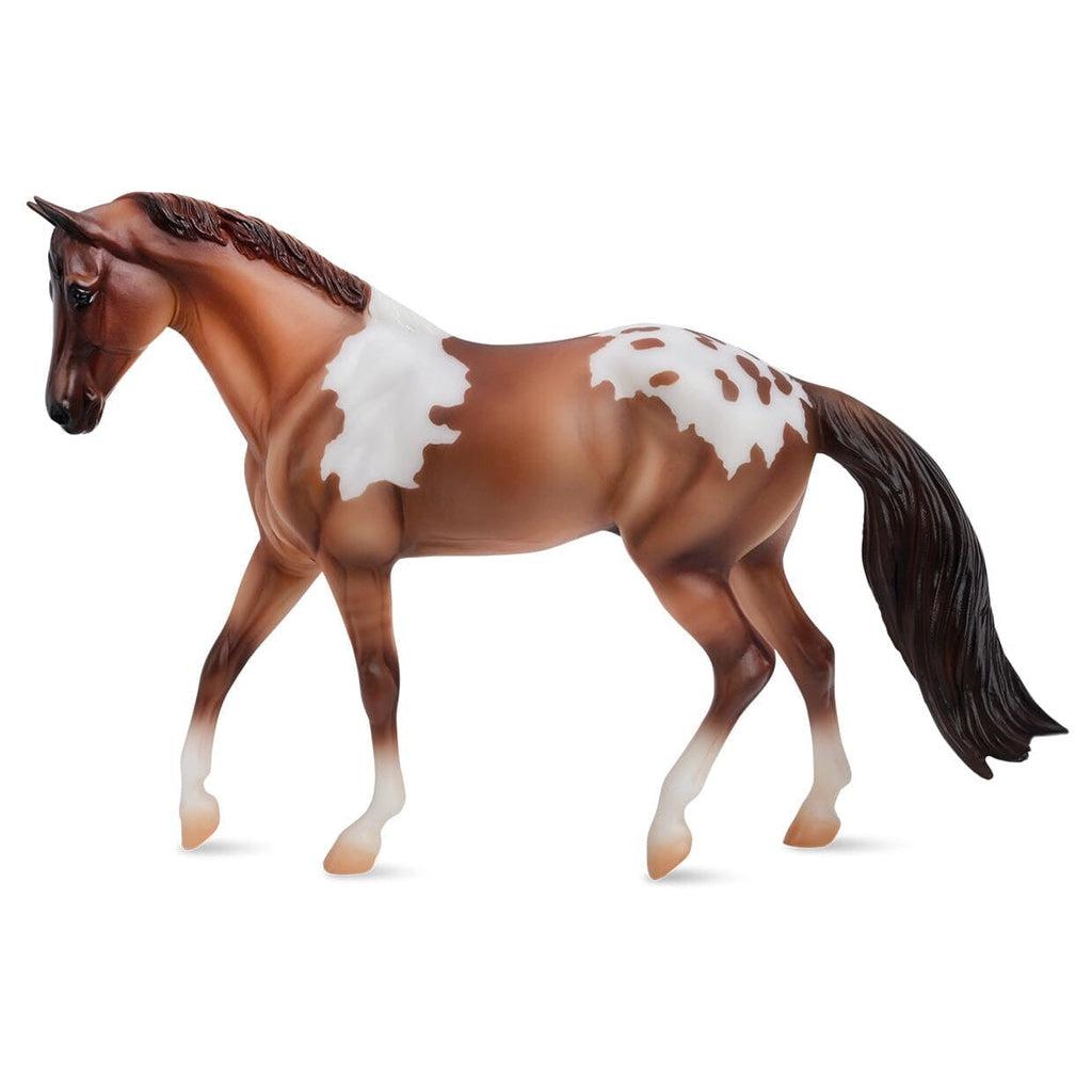 Image of the Red Dun Pintaloosa figurine. It is a red-brown horse with odd large white spots on its back. It has a black mane and tail.