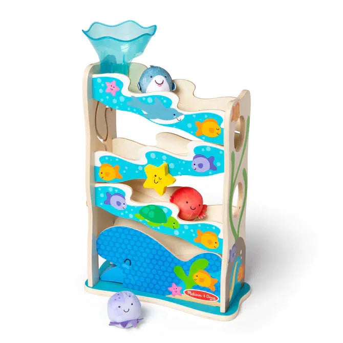 Image of the toy outside of the packaging. The toy is a structure with slanted platforms leading down to the floor. You can roll different sea creature themed round beanbags down it.It is mainly blue colored with lots of different pictures of ocean animals (fish, sharks, turtles, etc.) on it. 