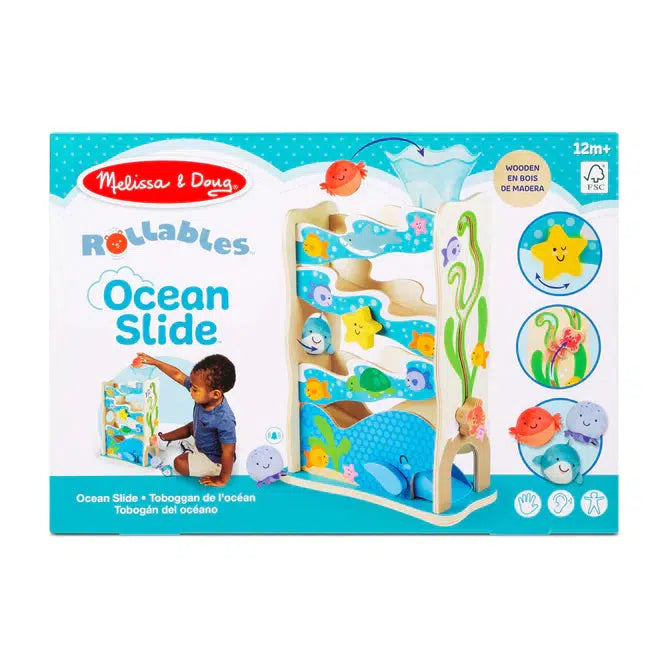 Image of the packaging for the Rollables Wooden Ocean Slide. On the front is a picture of the toy and another picture of a little boy playing with the toy.
