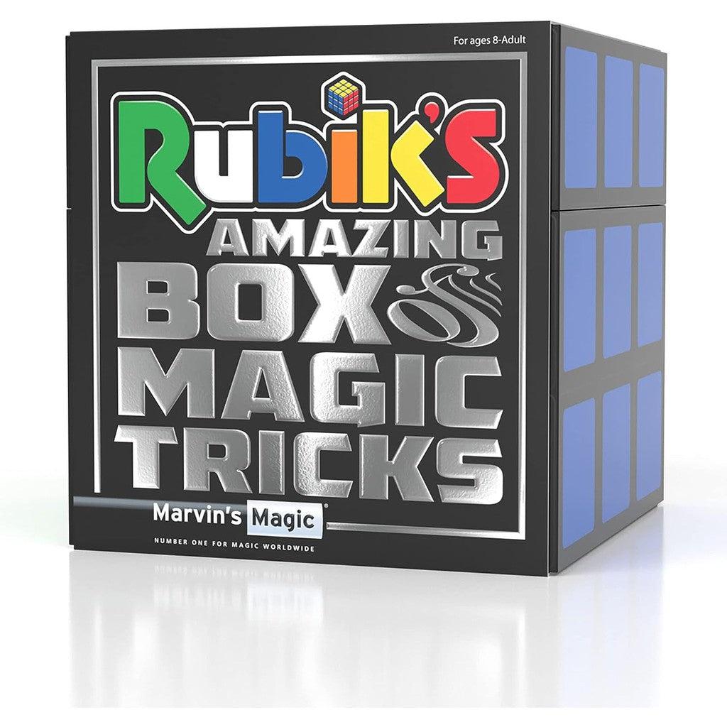 this image shows Rubik;s amazing box of magic tricks. its a magric trick guide with a rubik's cube inside. the box is shaped like a giant rubiks cube