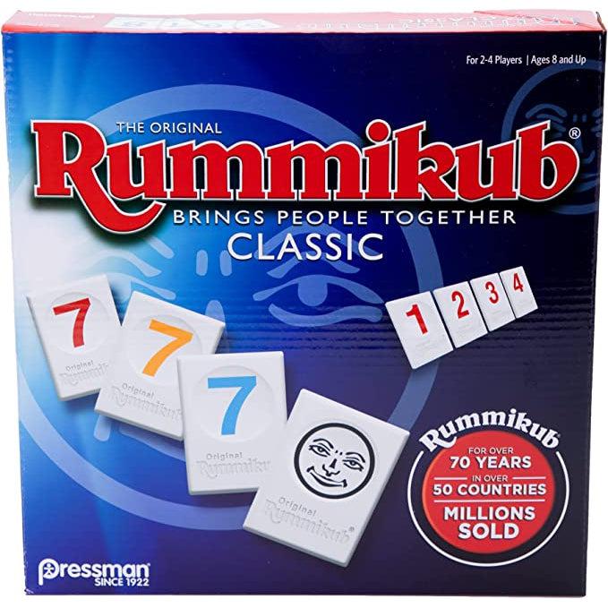 Image of the box for Rummikub Classic game. On the front is a picture of some of the game tiles on a blue ombre background.