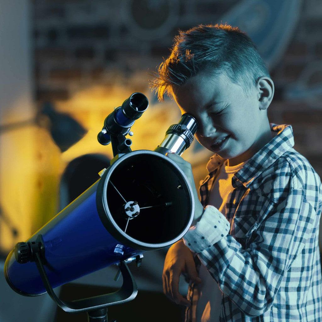 this image shows a kid looking through the telescope and seeing the stars