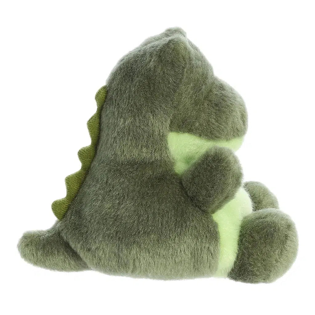 View of the side of the alligator plush. From this angle you can see that he has a tail in the back with felt spiky scales leading from his head to the tip.