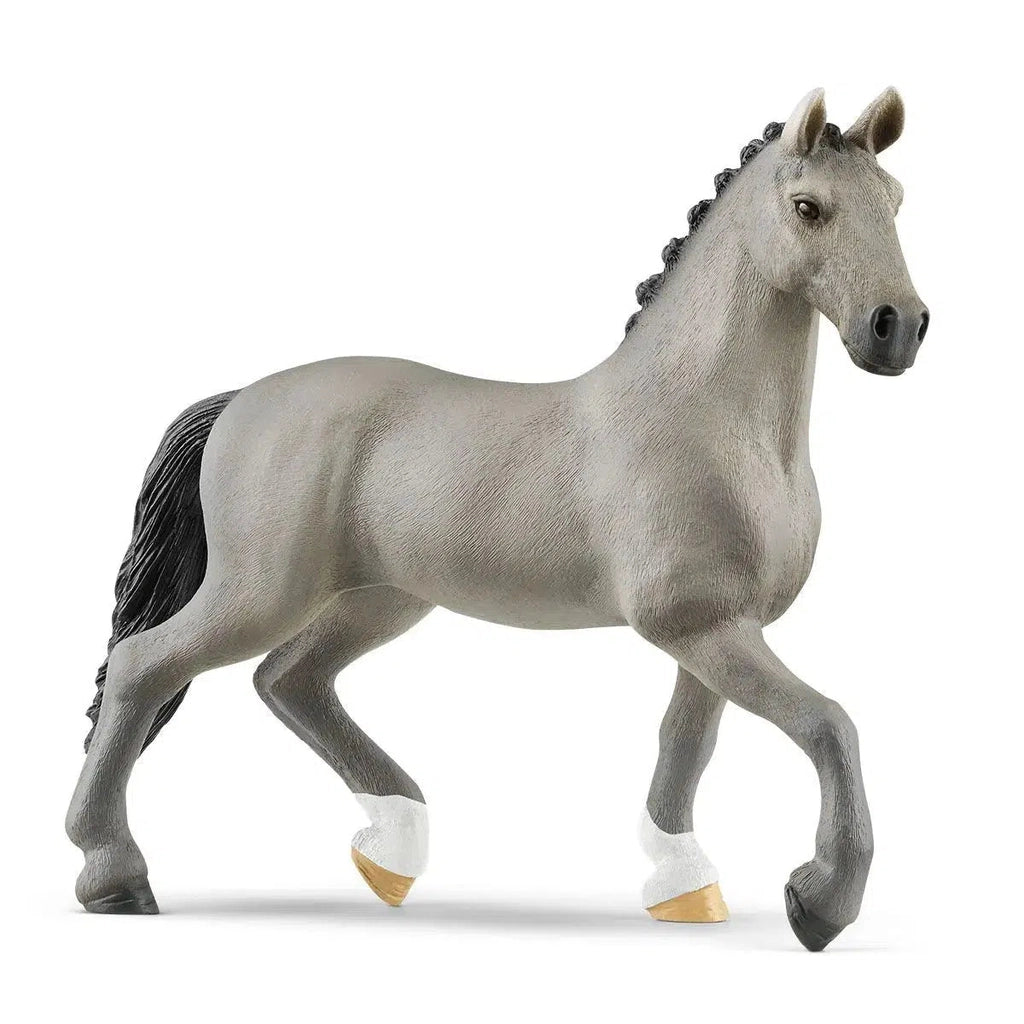 Image of the Selle Français Stallion figurine. It is a grey horse with a black mane and tail. Two of its hooves are white.