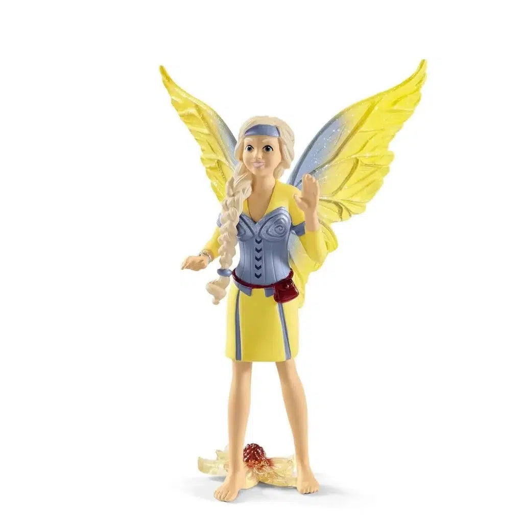 Image of the girl fairy figure. She is wearing a blue and yellow dress that matches her wings. She has long braided blonde hair.