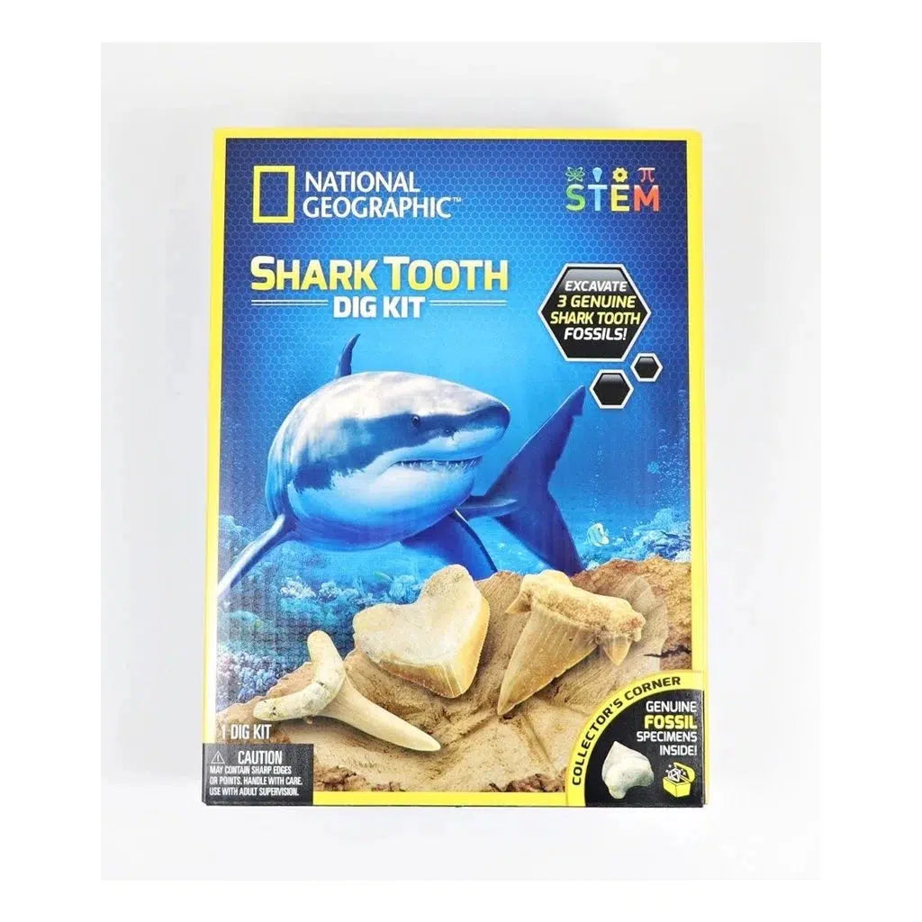 The national geographic shark tooth dig kit. a sign says excavate 3 genuine shark tooth fossils! there is a picture of a shark underwater, with three teeth fossils up close