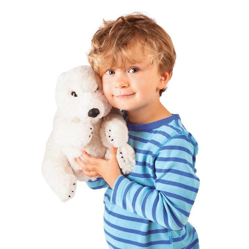 Young boy holding polar bear puppet on hand