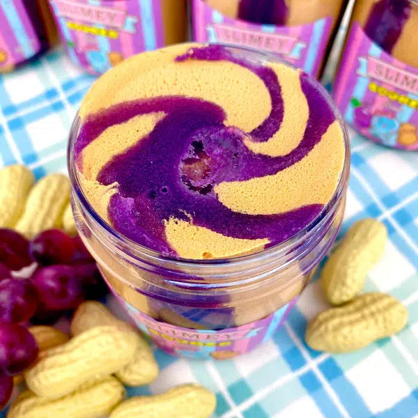 Image of the open slime. It is a tan and purple swirl in the jar just like the real product. When mixed it turns a lighter purple color.
