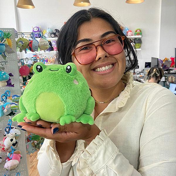 Person holding frog plush