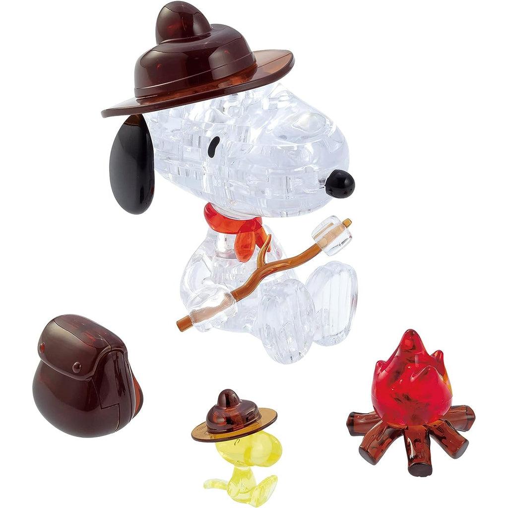 Image of the 3D Snoopy Camfire puzzle. It comes with a crystal snoopy in a brown camping hat, crystal Woodstock in a similar hat, a crystal campfire, and a crystal backpack.