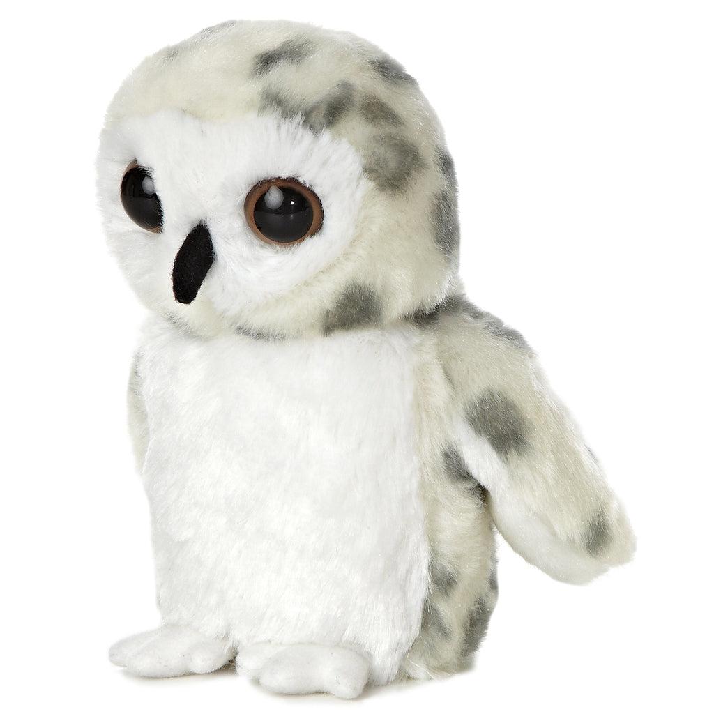 Side view of the owl plush. Shows that the black beak sticks out from the face. He has white feet facing the front.